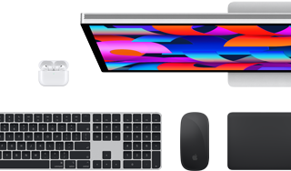 Colección de accesorios y dispositivos que incluye unos AirPods, un Magic Keyboard con Touch ID, un Magic Mouse, un Magic Trackpad y un Studio Display