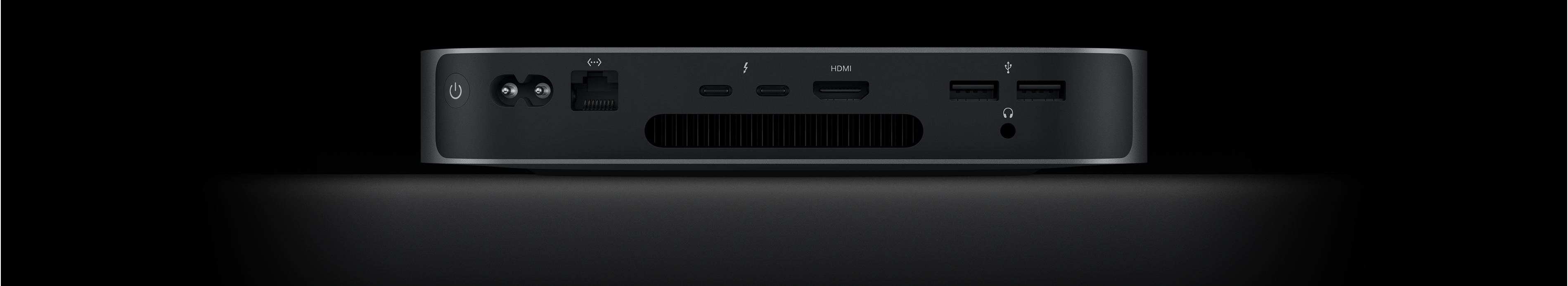 Vista trasera de un Mac mini que muestra los dos puertos Thunderbolt 4, el puerto HDMI, los dos puertos USB-A, la toma para auriculares, el puerto Gigabit Ethernet, la toma de corriente y el botón de encendido.